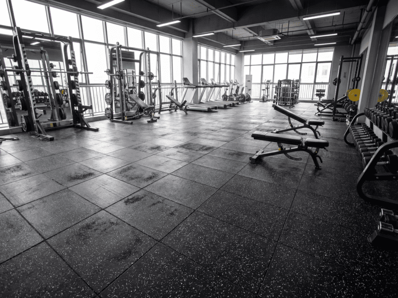 Photo comparison of flat rubber flooring vs buckled seams due to humidity